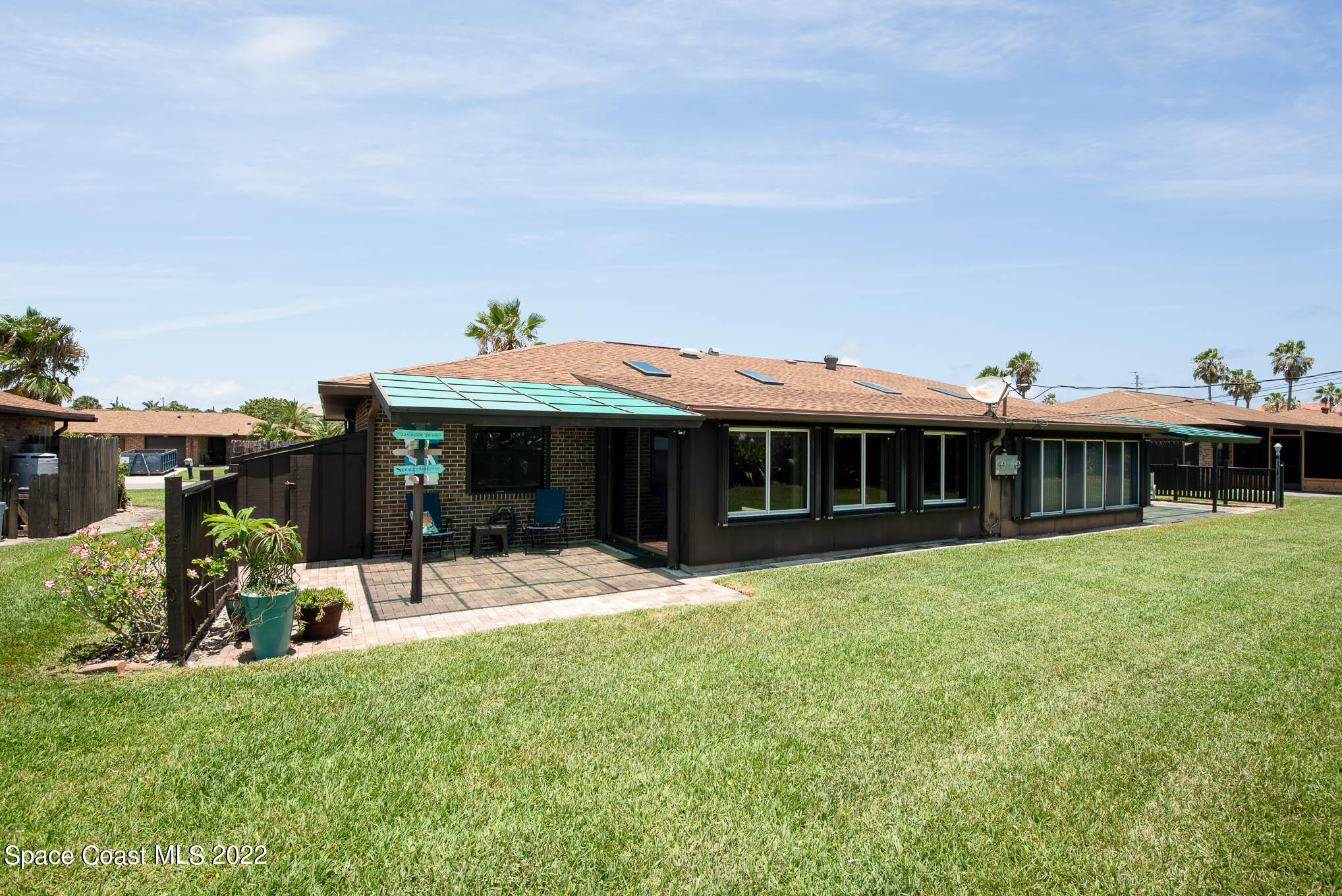 115 Normandy Place Melbourne Beach, FL 32951 - Photo 19 of 31 a front view of a house with a yard and seating area