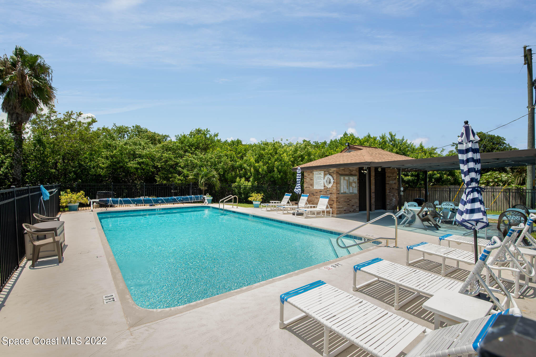 115 Normandy Place Melbourne Beach, FL 32951 - Photo 20 of 31 an outdoor space with furniture and umbrella