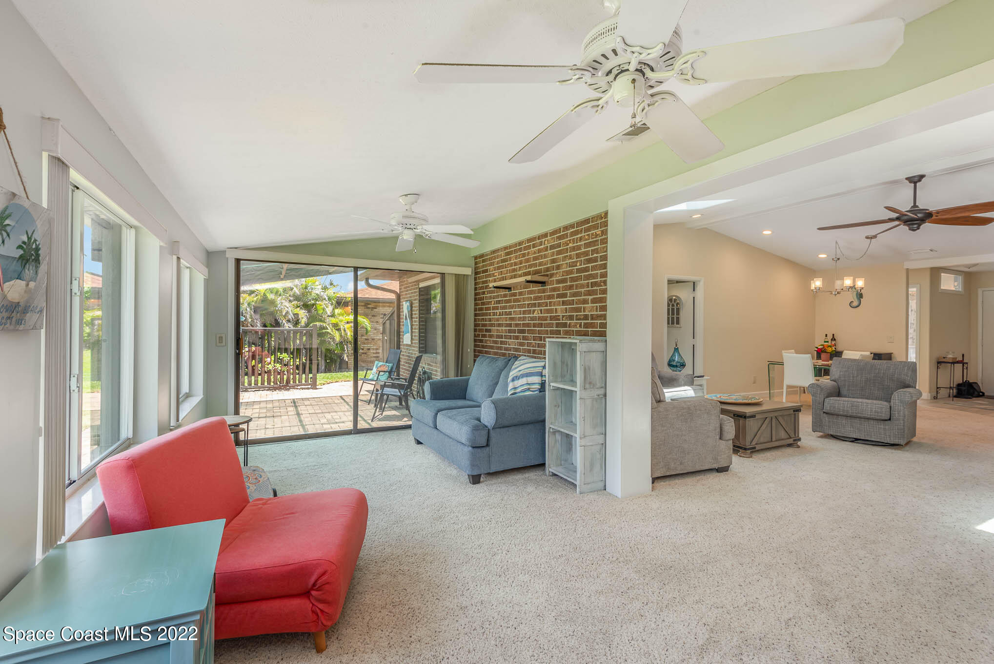 115 Normandy Place Melbourne Beach, FL 32951 - Photo 7 of 31 a living room with furniture and a floor to ceiling window