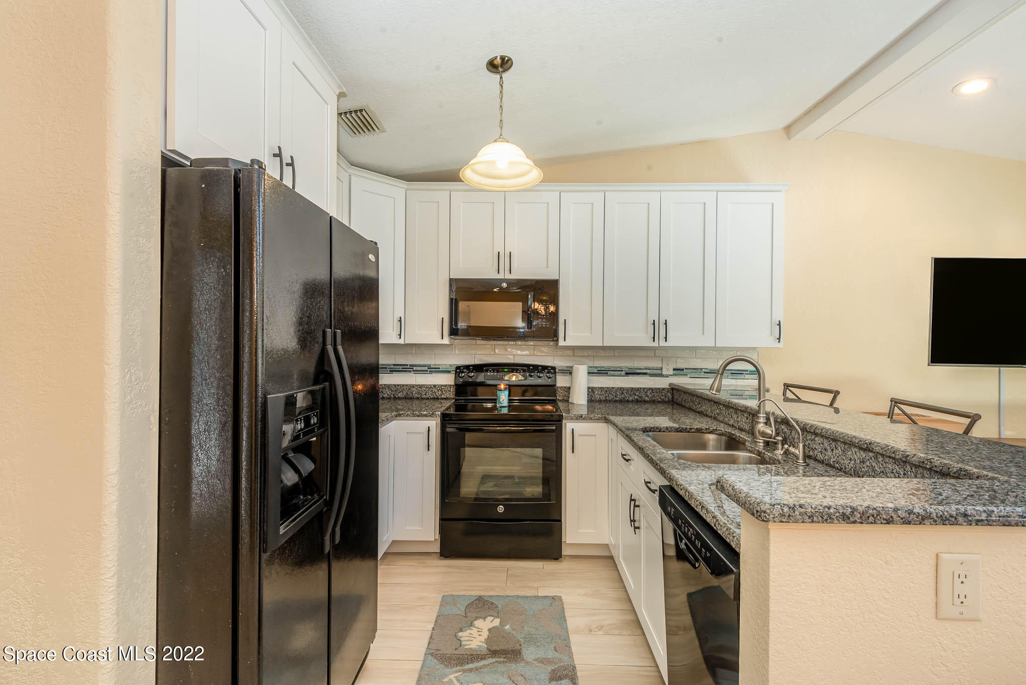 115 Normandy Place Melbourne Beach, FL 32951 - Photo 8 of 31 a kitchen with a sink stove and refrigerator