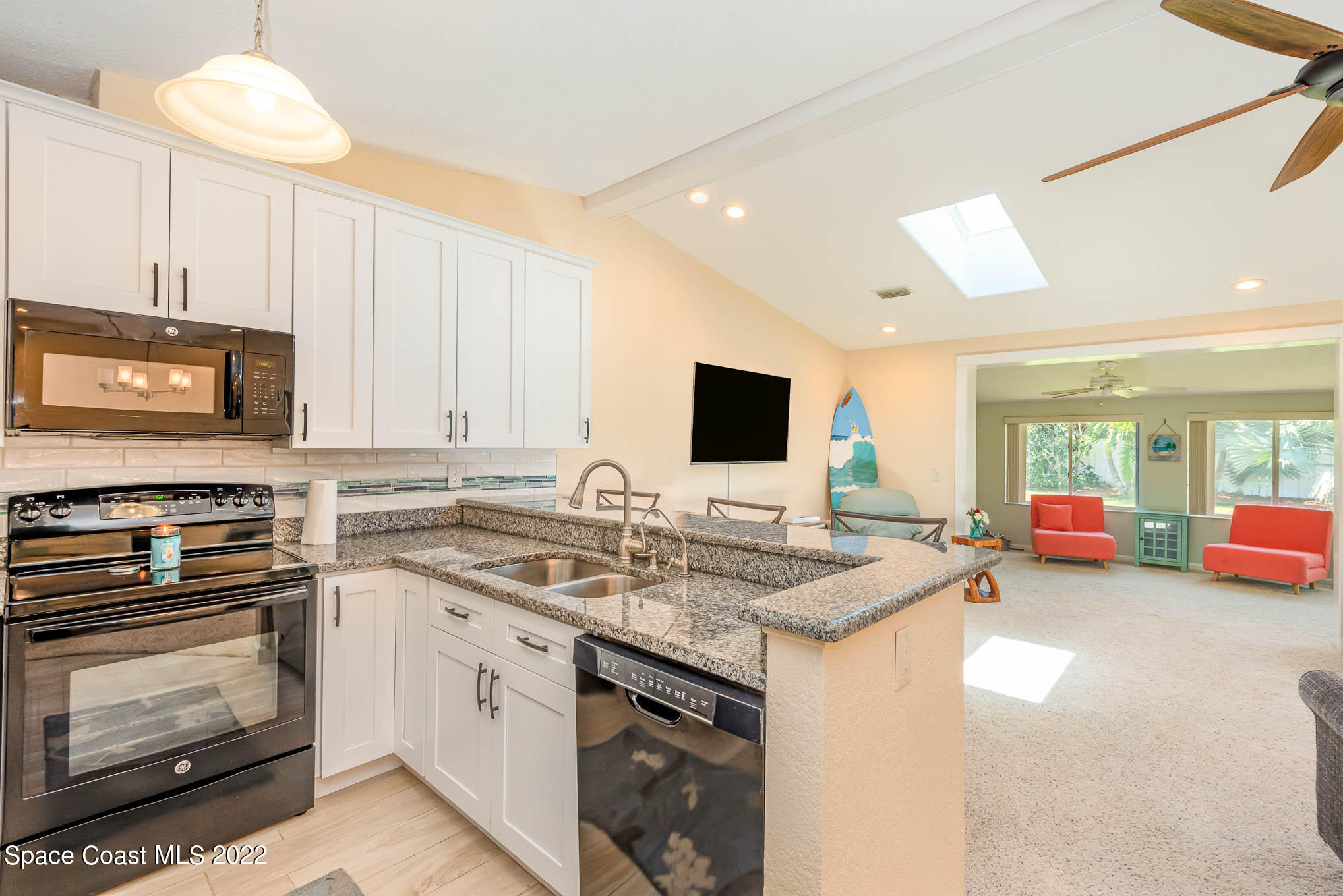 115 Normandy Place Melbourne Beach, FL 32951 - Photo 9 of 31 a kitchen that has a stove and a microwave