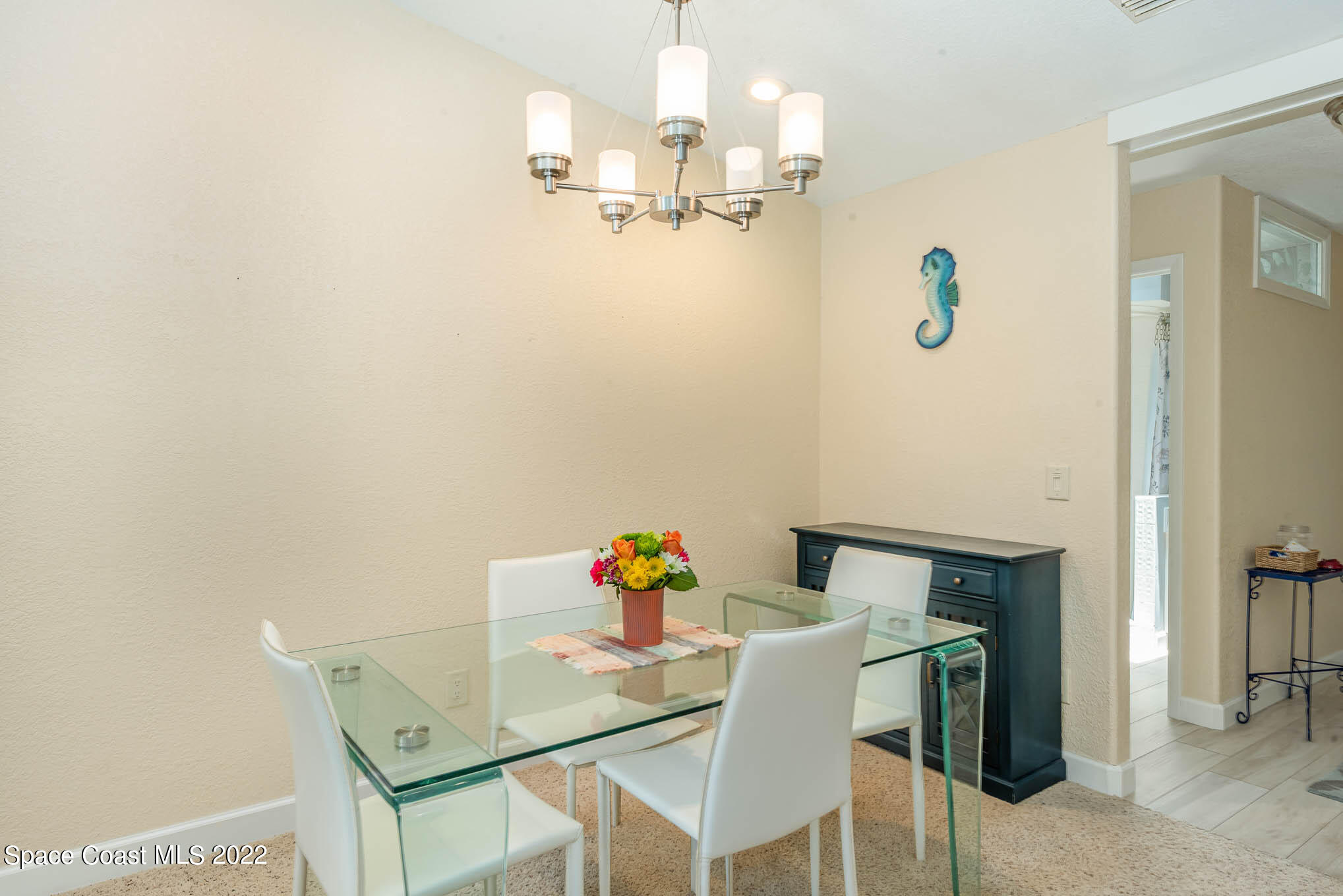 115 Normandy Place Melbourne Beach, FL 32951 - Photo 10 of 31 a dining room with furniture and chandelier