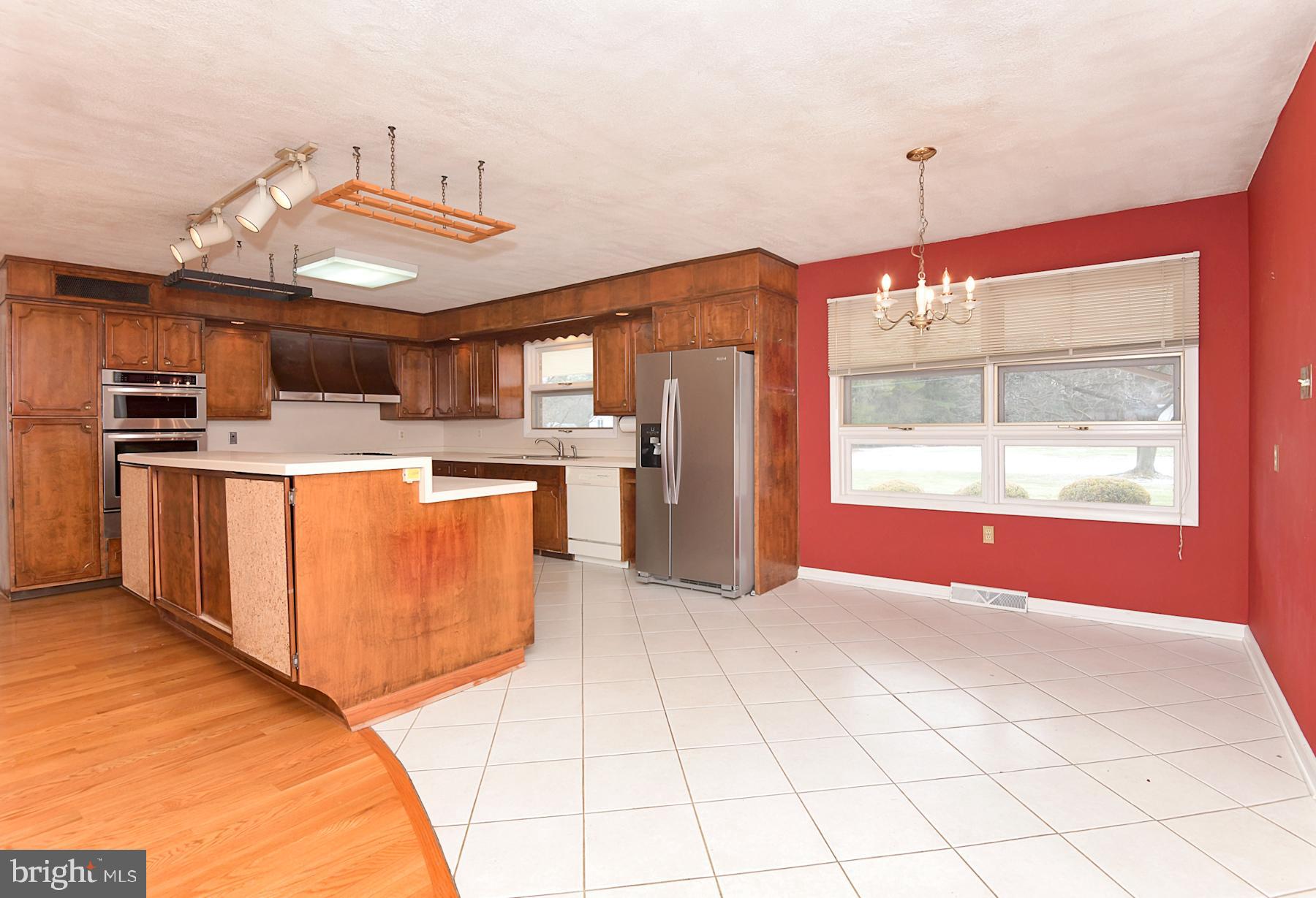 28 West Church Road Lawrence Township, NJ 08648 - Photo 12 of 32 a open kitchen with stainless steel appliances granite countertop a stove top oven a sink dishwasher and a refrigerator