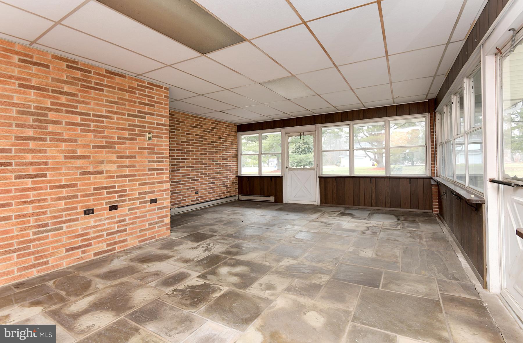 28 West Church Road Lawrence Township, NJ 08648 - Photo 19 of 32 a view of empty room with a fireplace and windows