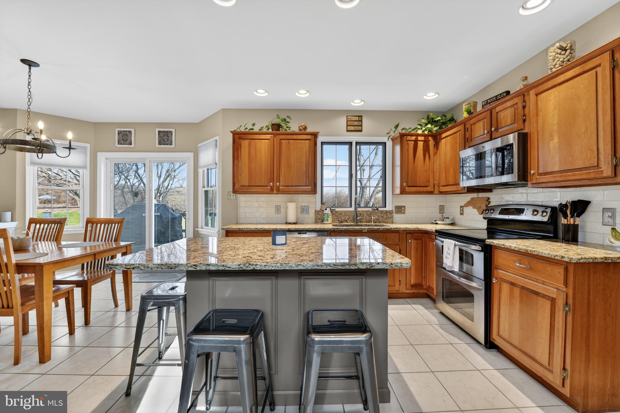 110 Pennsylvania Avenue Sinking Spring, PA 19608 - Photo 13 of 53 a kitchen with stainless steel appliances granite countertop a stove a sink dishwasher and a refrigerator with wooden cabinets