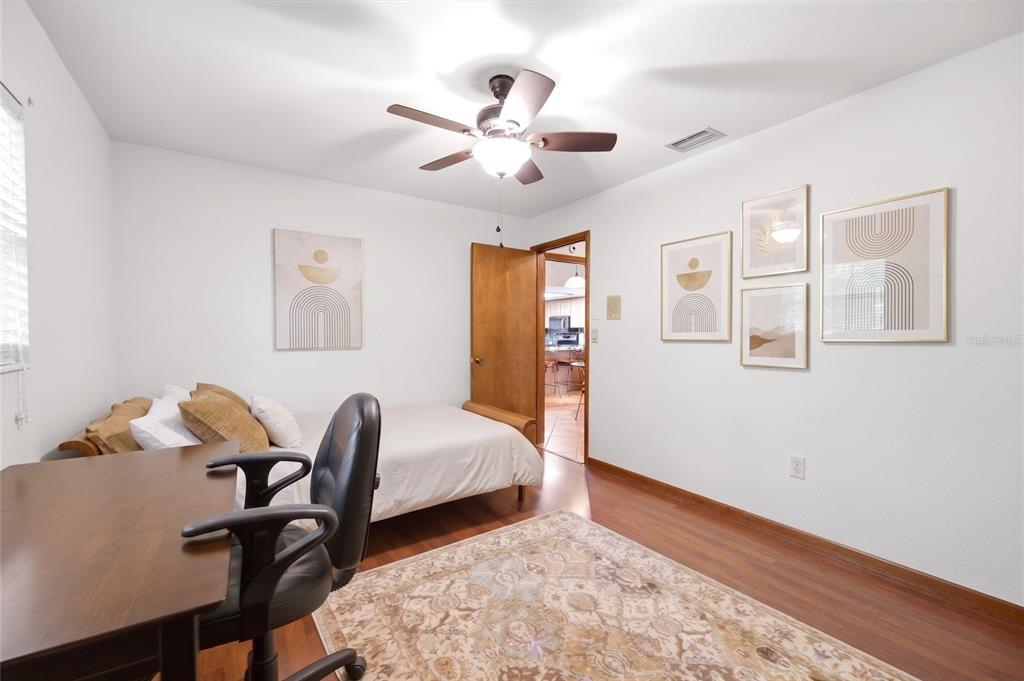 5227 Suwannee Road Weeki Wachee, FL 34607 - Photo 29 of 62 a bedroom with bed and a chandelier