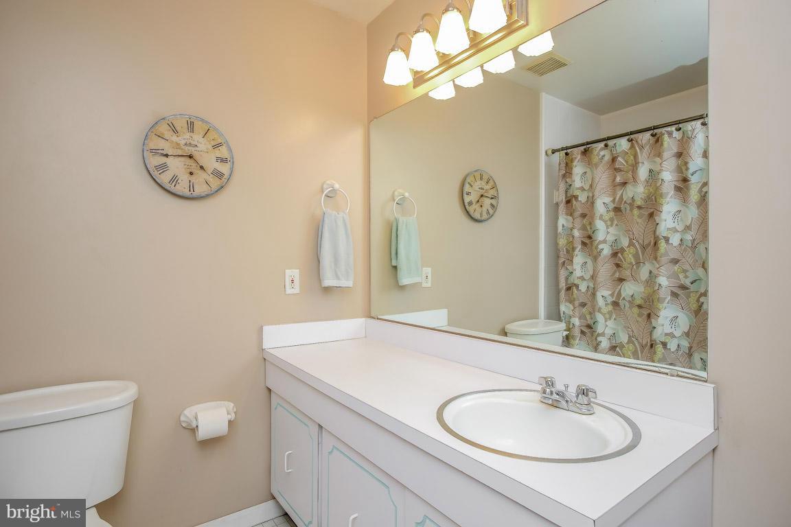 2572 Riva Road, Unit 16B Annapolis, MD 21401 - Photo 17 of 22 a bathroom with a toilet sink vanity and mirror