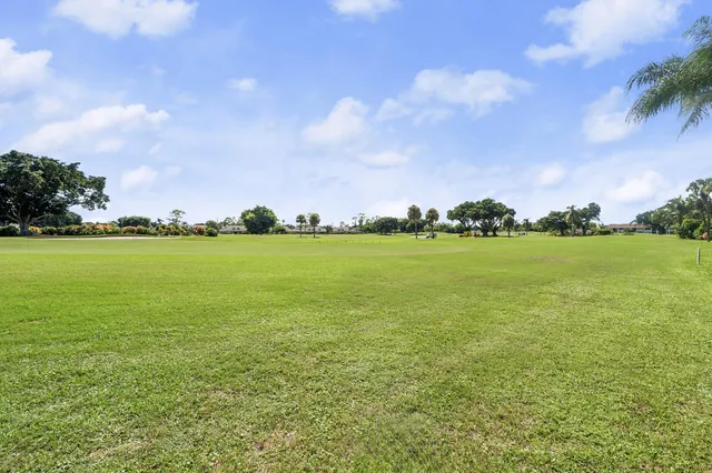 a view of a big yard with lots of buildings in the background