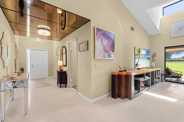 a spacious bedroom with a bed and a flat screen television