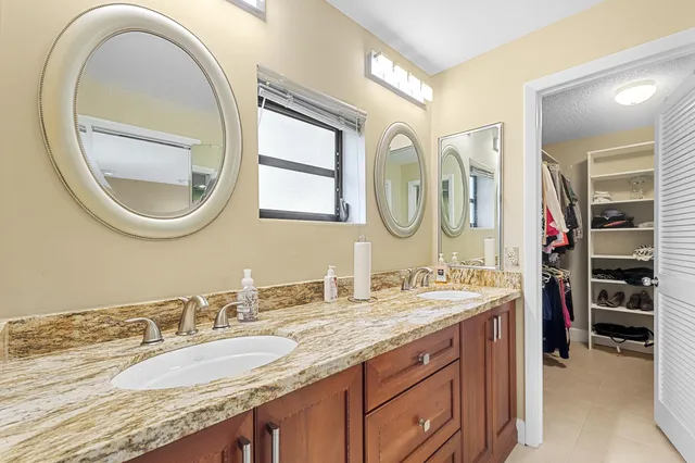 a living room with furniture a flat screen tv and a table