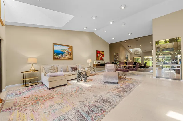 a living room with couch and a floor to ceiling window