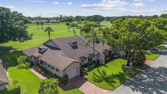 an aerial view of a house with a garden and swimming pool