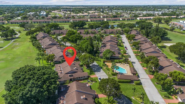 an aerial view of residential houses with outdoor space and trees
