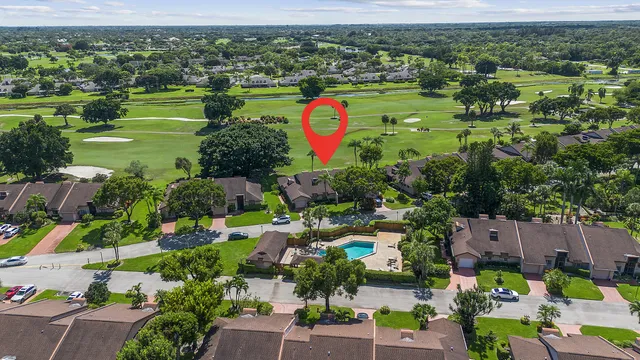 an aerial view of residential houses with outdoor space and swimming pool