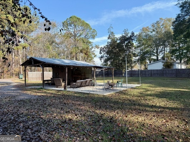822 North Lewis Street Metter, GA 30439 - Photo 19 of 19 a backyard of a house with table and chairs