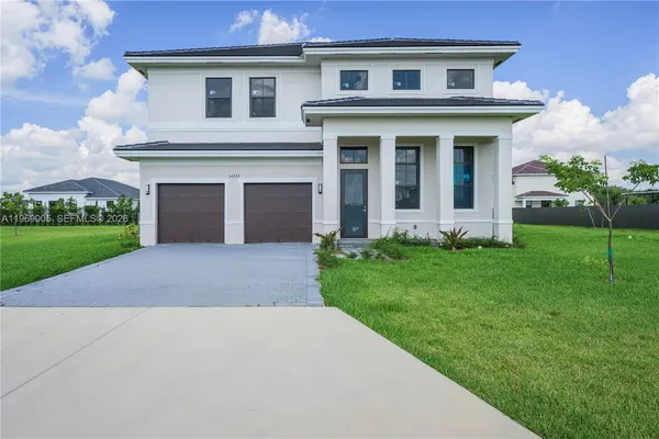 a front view of house with yard and green space