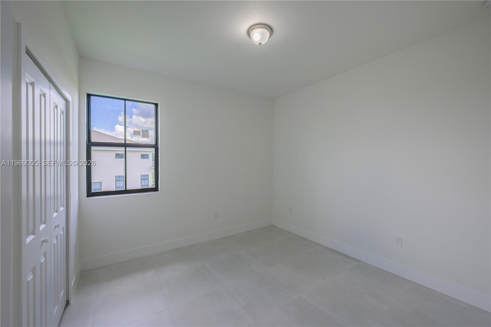 32242 Southwest 194th Avenue Homestead, FL 33030 - Photo 13 of 42 an empty room with windows