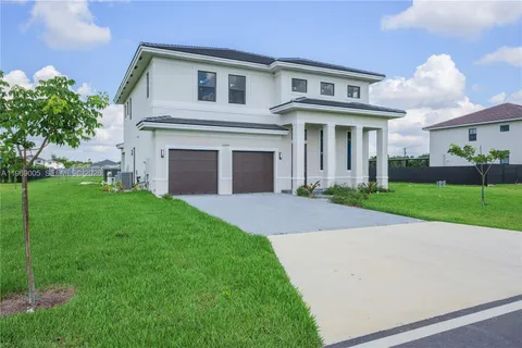 a front view of a brick house with a yard