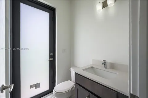 a bathroom with a sink toilet and vanity