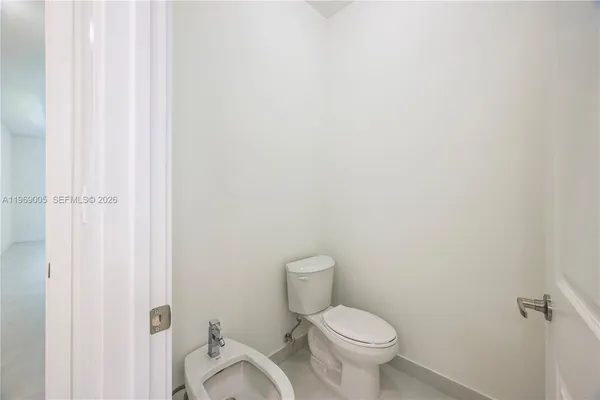 a white toilet sitting next to a shower
