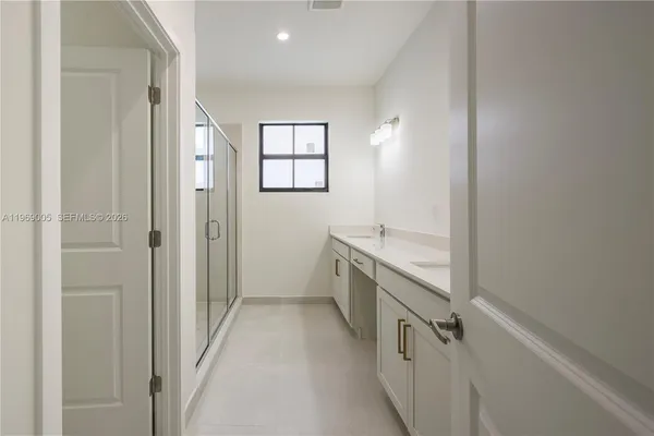 a bathroom with a sink a mirror and a shower
