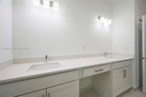 a bathroom with a sink and a white cabinet