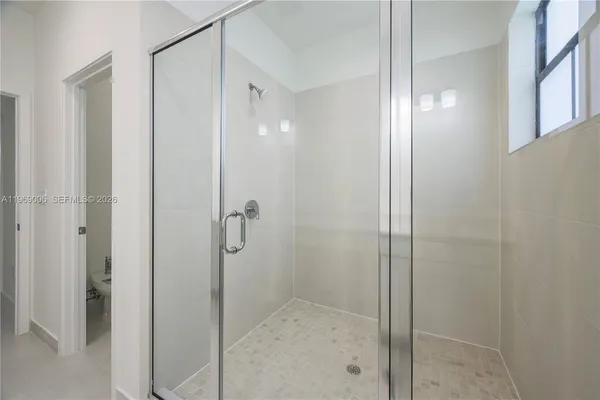 a bathroom with a glass shower door