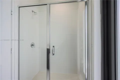 a bathroom with a glass shower door