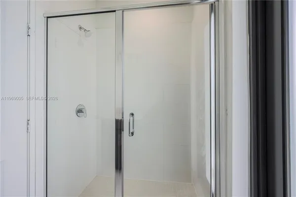 a bathroom with a glass shower door