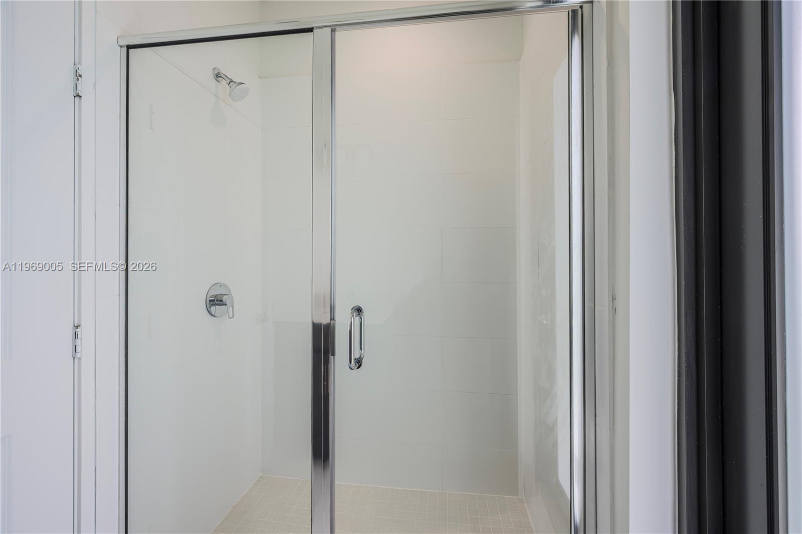 32242 Southwest 194th Avenue Homestead, FL 33030 - Photo 27 of 42 a bathroom with a glass shower door