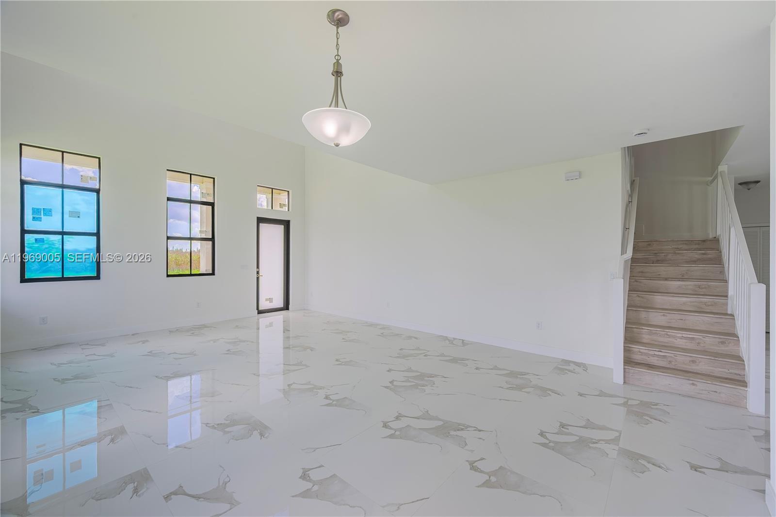 32242 Southwest 194th Avenue Homestead, FL 33030 - Photo 6 of 42 a view of an empty room with a window