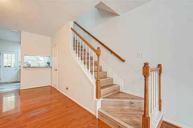 a view of entryway and hall with wooden floor
