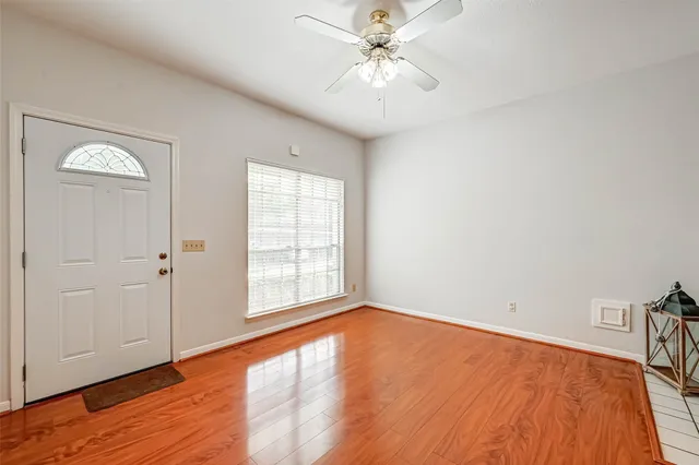 wooden floor in an empty room with a window