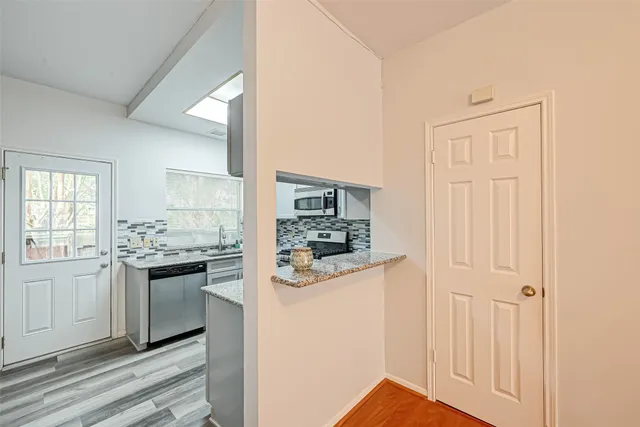a kitchen with stainless steel appliances granite countertop a stove and a refrigerator