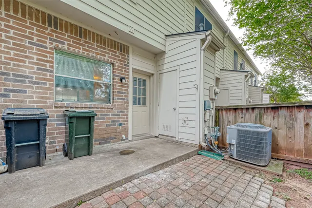 a backyard of a house with oven and glass door