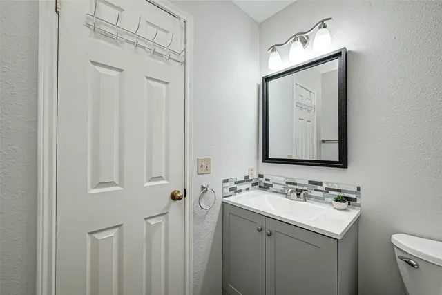 a bathroom with a sink vanity and a mirror