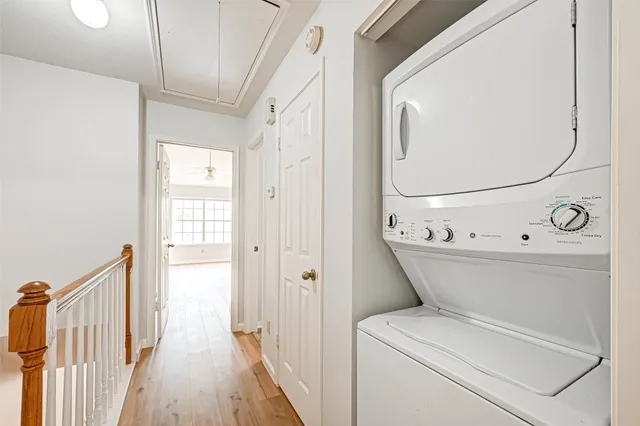a view of washer and dryer with bathroom in the background