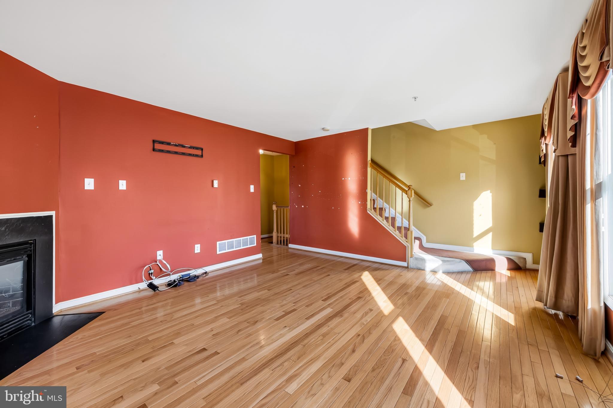 252 Robert Street Baltimore, MD 21217 - Photo 12 of 51 a view of a livingroom with wooden floor and a fireplace