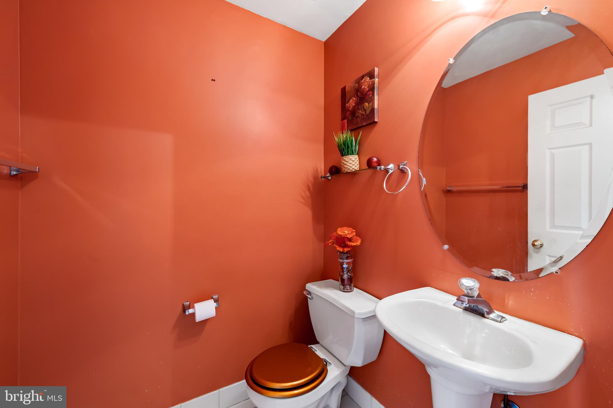 252 Robert Street Baltimore, MD 21217 - Photo 14 of 51 a bathroom with a toilet a sink and mirror