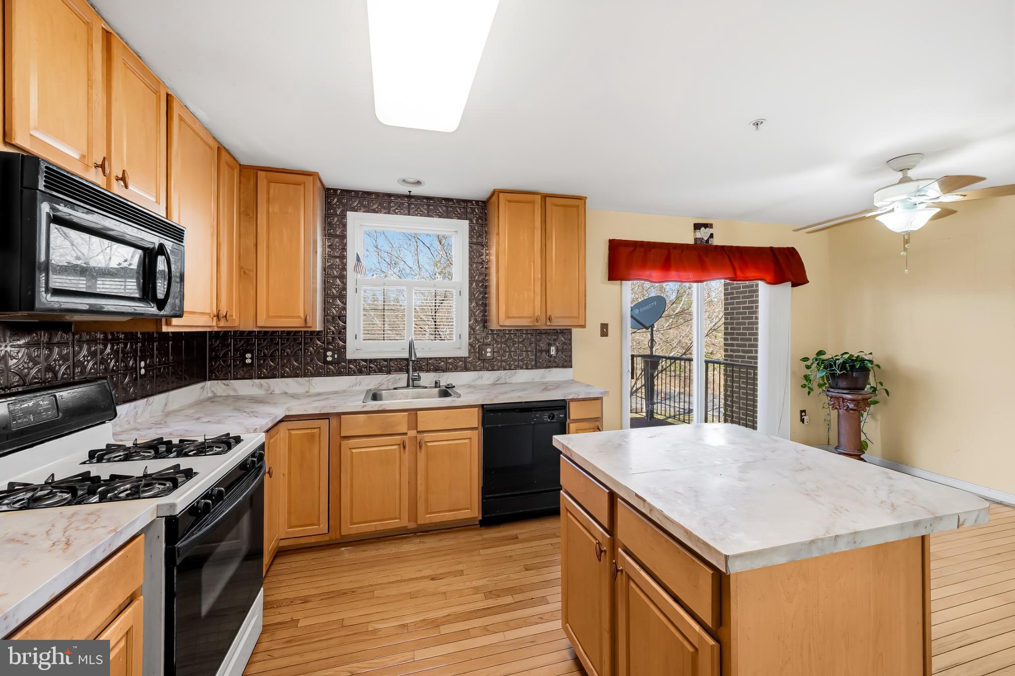 252 Robert Street Baltimore, MD 21217 - Photo 17 of 51 a kitchen with stainless steel appliances granite countertop a stove a sink dishwasher and a microwave