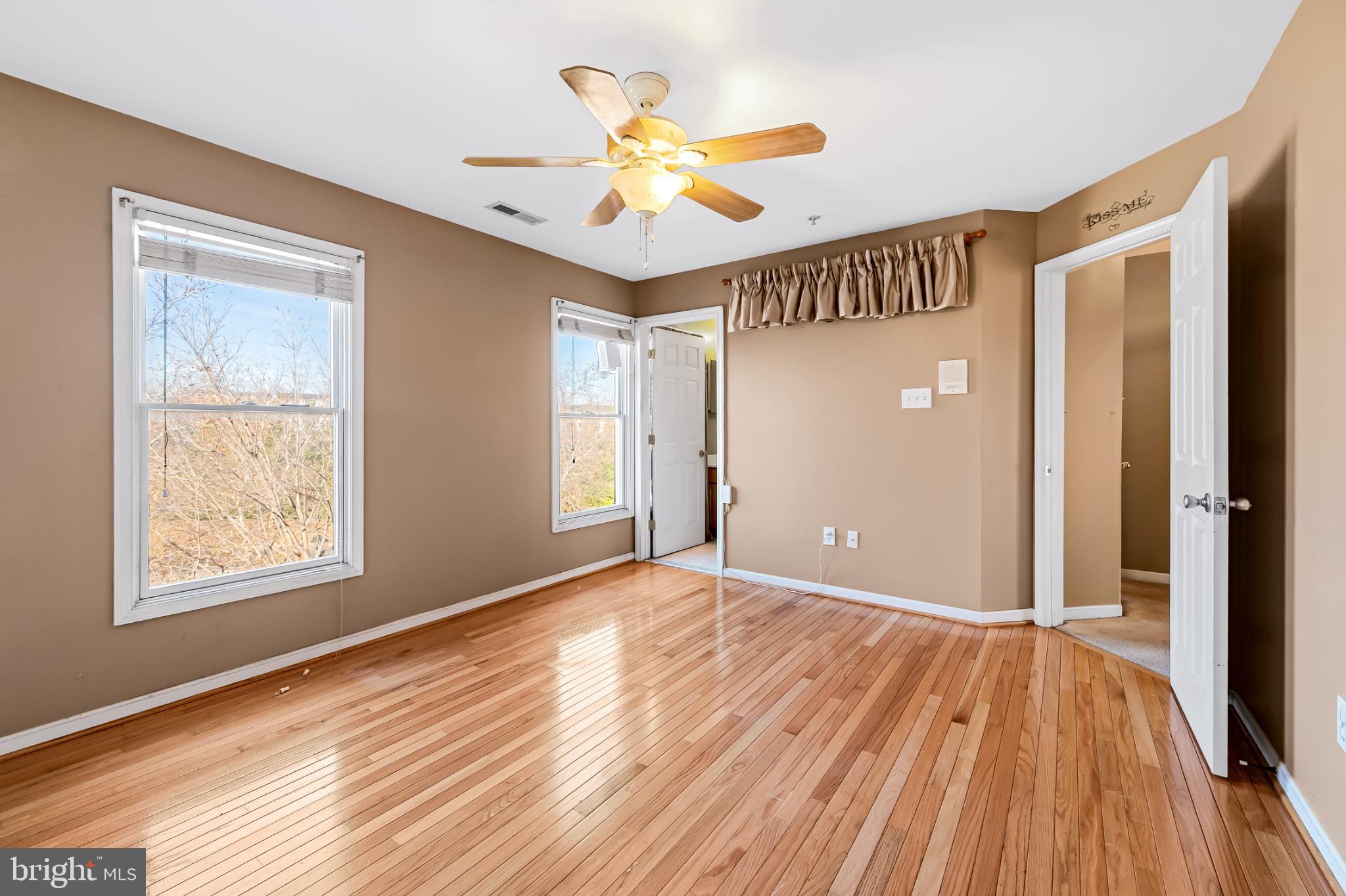 252 Robert Street Baltimore, MD 21217 - Photo 25 of 51 a view of an empty room with wooden floor and a window
