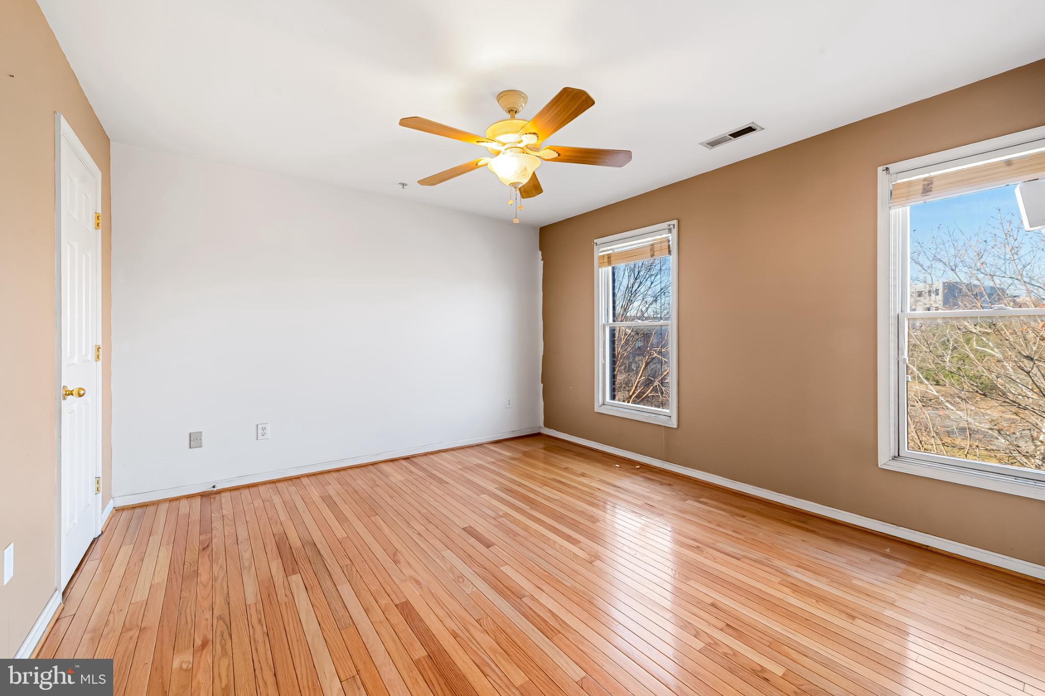 252 Robert Street Baltimore, MD 21217 - Photo 26 of 51 a view of an empty room with wooden floor and a window