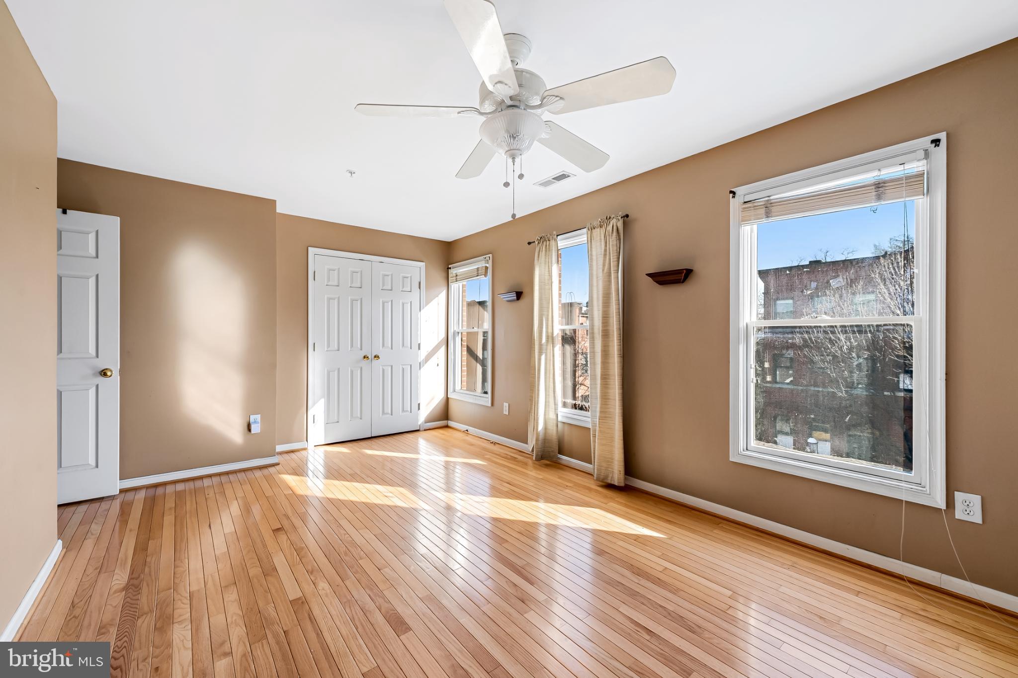 252 Robert Street Baltimore, MD 21217 - Photo 30 of 51 a view of an empty room with wooden floor and a window