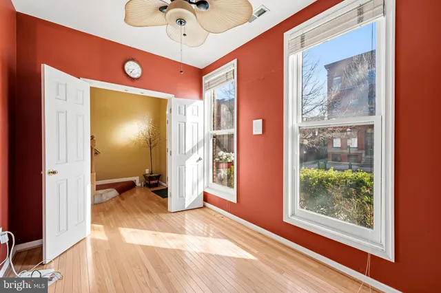 a view of an empty room with a fireplace and a window