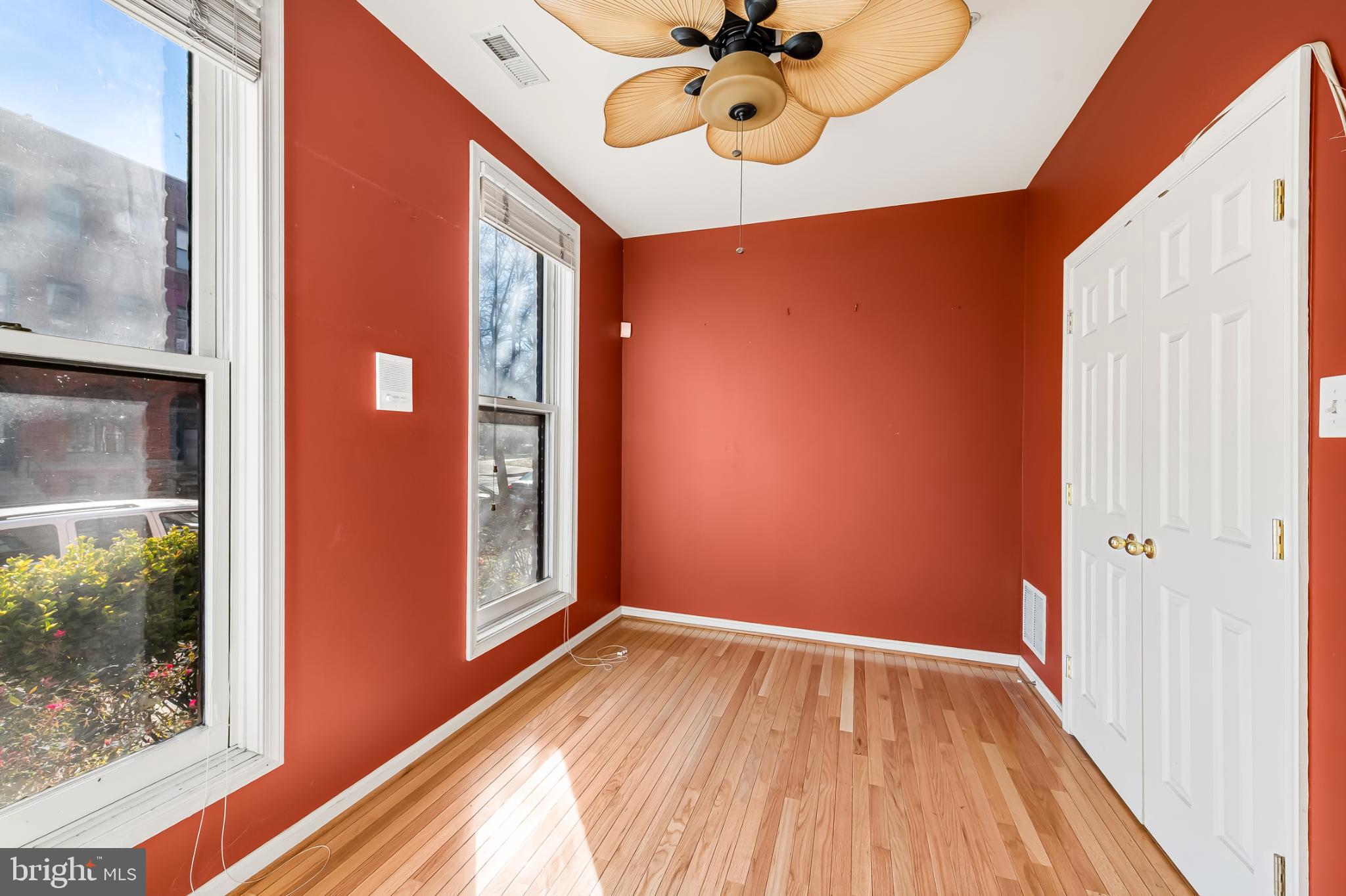 252 Robert Street Baltimore, MD 21217 - Photo 7 of 51 a view of an empty room with a window and wooden floor