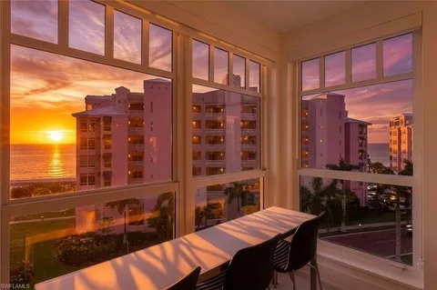 a view of a balcony dining table and chairs