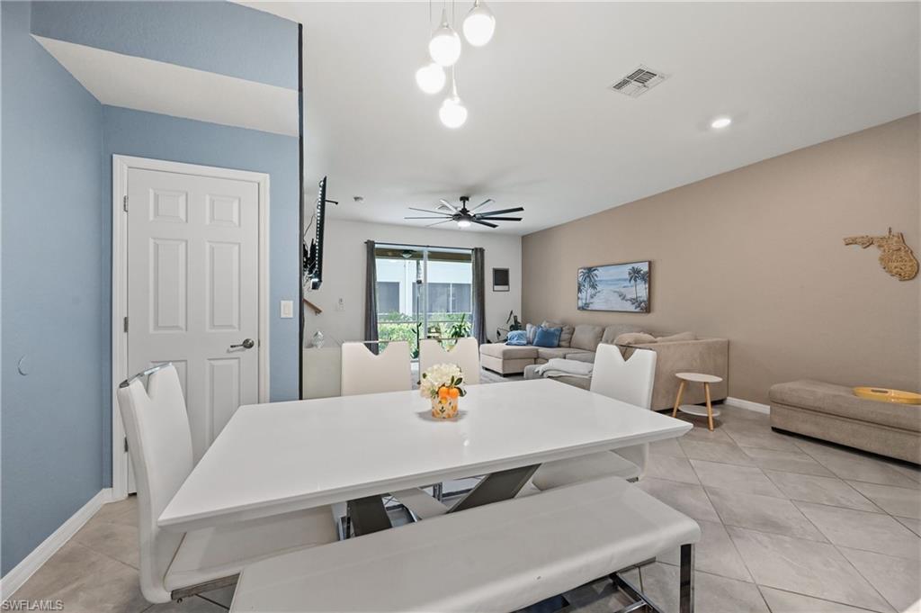 2828 Citrus Street Naples, FL 34120 - Photo 11 of 40 a living room with furniture and a chandelier