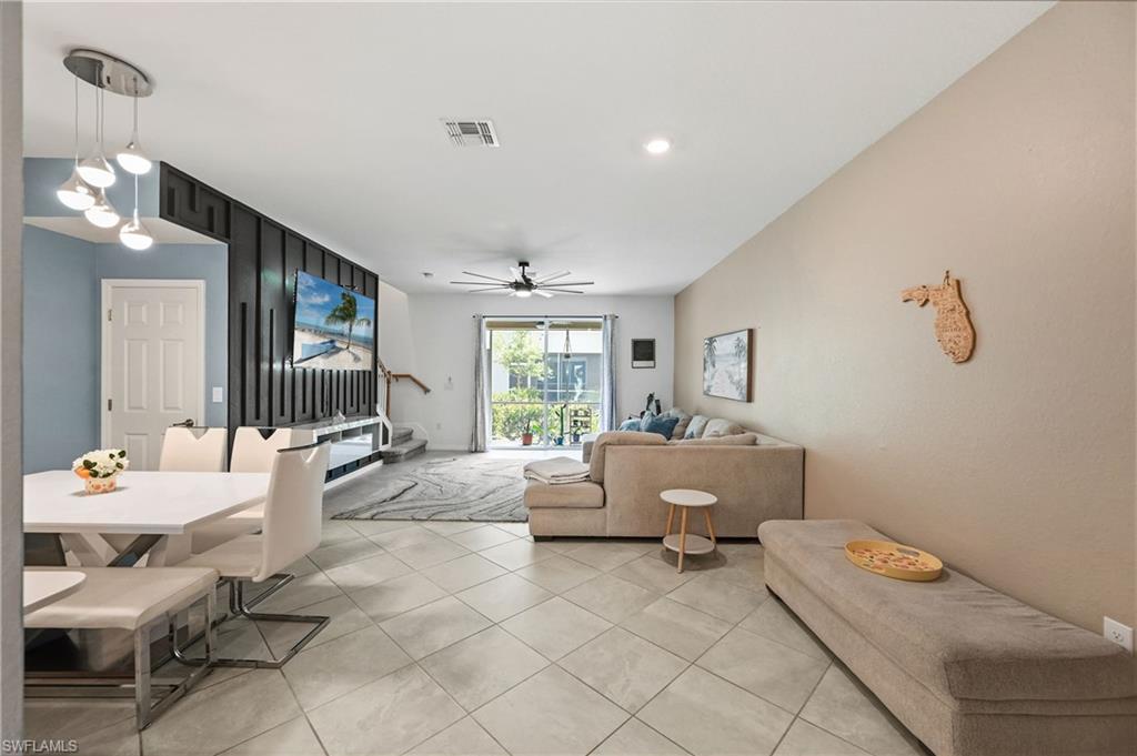 2828 Citrus Street Naples, FL 34120 - Photo 17 of 40 a living room with furniture and a chandelier