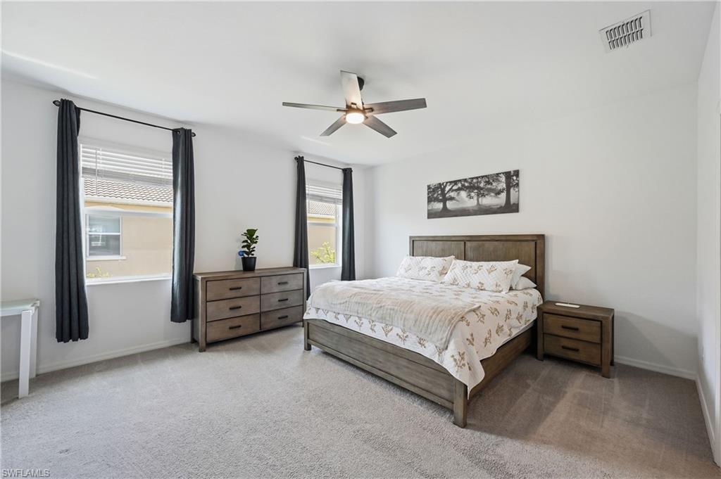 2828 Citrus Street Naples, FL 34120 - Photo 18 of 40 a bed room with a bed and a chandelier