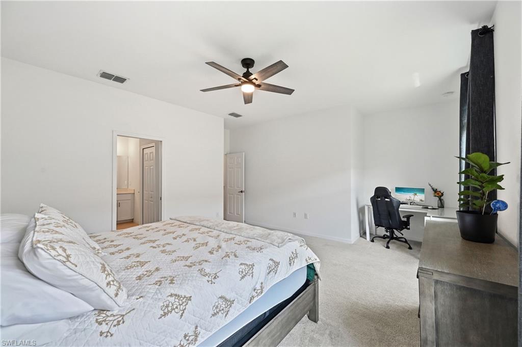 2828 Citrus Street Naples, FL 34120 - Photo 20 of 40 a bedroom with a bed and a potted plant